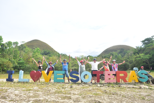 Exploring the Chocolate Hills of Bohol Island on an off-road buggy car ride during a fun-filled tour.
