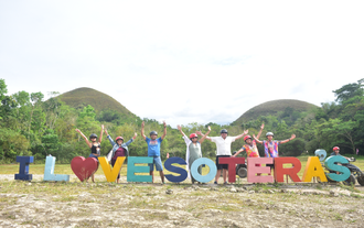 Exploring the Chocolate Hills of Bohol Island on an off-road buggy car ride during a fun-filled tour.