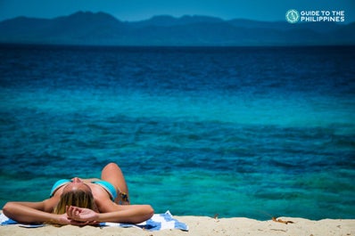 Girl sunbathing in Coron