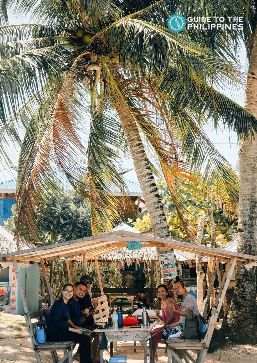 Travelers having lunch at Daku Island Siargao Travelers having lunch at Daku Island Siargao