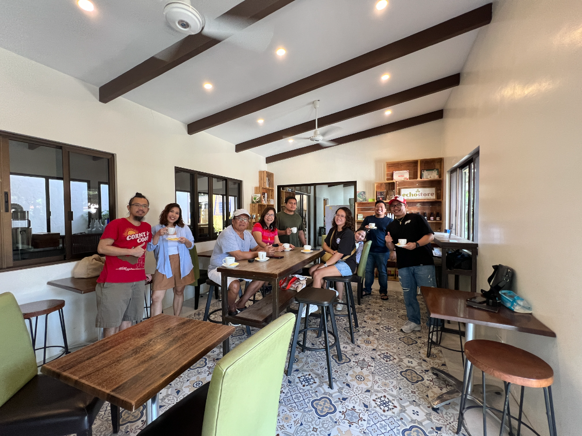 Tourists enjoying a cup of coffee during a coffee tour near Tagaytay City