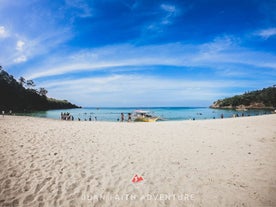 Clear turquoise water and soft sand at Laki Beach, a peaceful stop featured on this beach day trip near Manila City