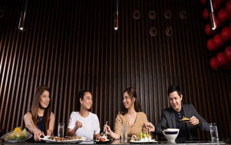 Happy guests enjoying their dining credits at one of Okada Manila Hotel’s restaurants during this day tour in Manila City