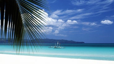 Enjoy the picturesque views of Boracay Island's white sands and crystal-clear waters during your vacation package.