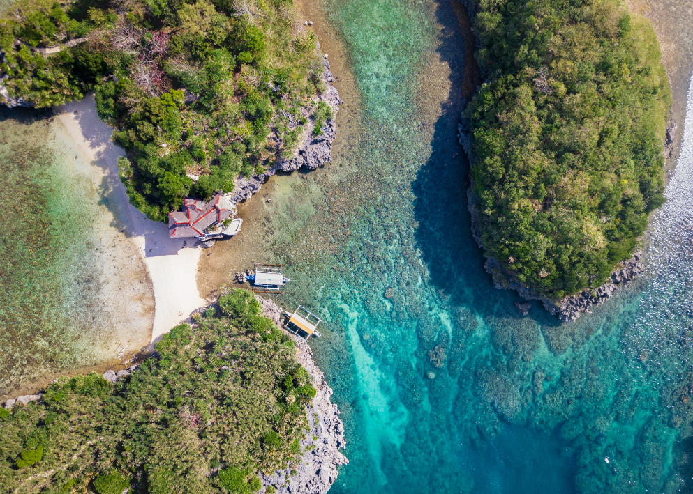 An aerial view of the white sand and blue waters of Natago Beach, one of the stops on this Guimaras Island hopping tour
