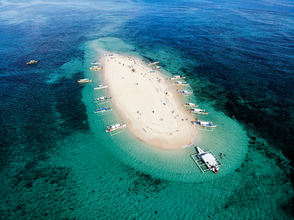 Visit Siargao’s Naked Island, perfect for sunbathing and swimming