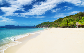 The beautiful view of the pristine white sand of Malcapuya Island, a part of this island hopping tour C in Coron town