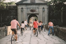 Biking in front of the Puerta Del Parian