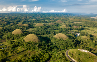 The rolling landscapes of Bohol Island’s Chocolate Hills, with an ATV ride offering an exciting way to explore them up close.