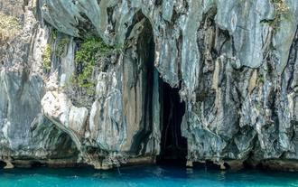 Visitors can explore the breathtaking Cathedral Cave, surrounded by towering cliffs and crystal-clear waters, as part of the El Nido island hopping tour B.