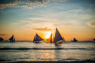 Paraw sailing boats in Boracay Island during a sunset