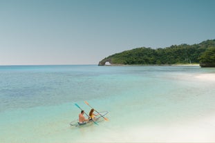 Two tourists enjoying the calm waters on a crystal kayak ride in Boracay Island