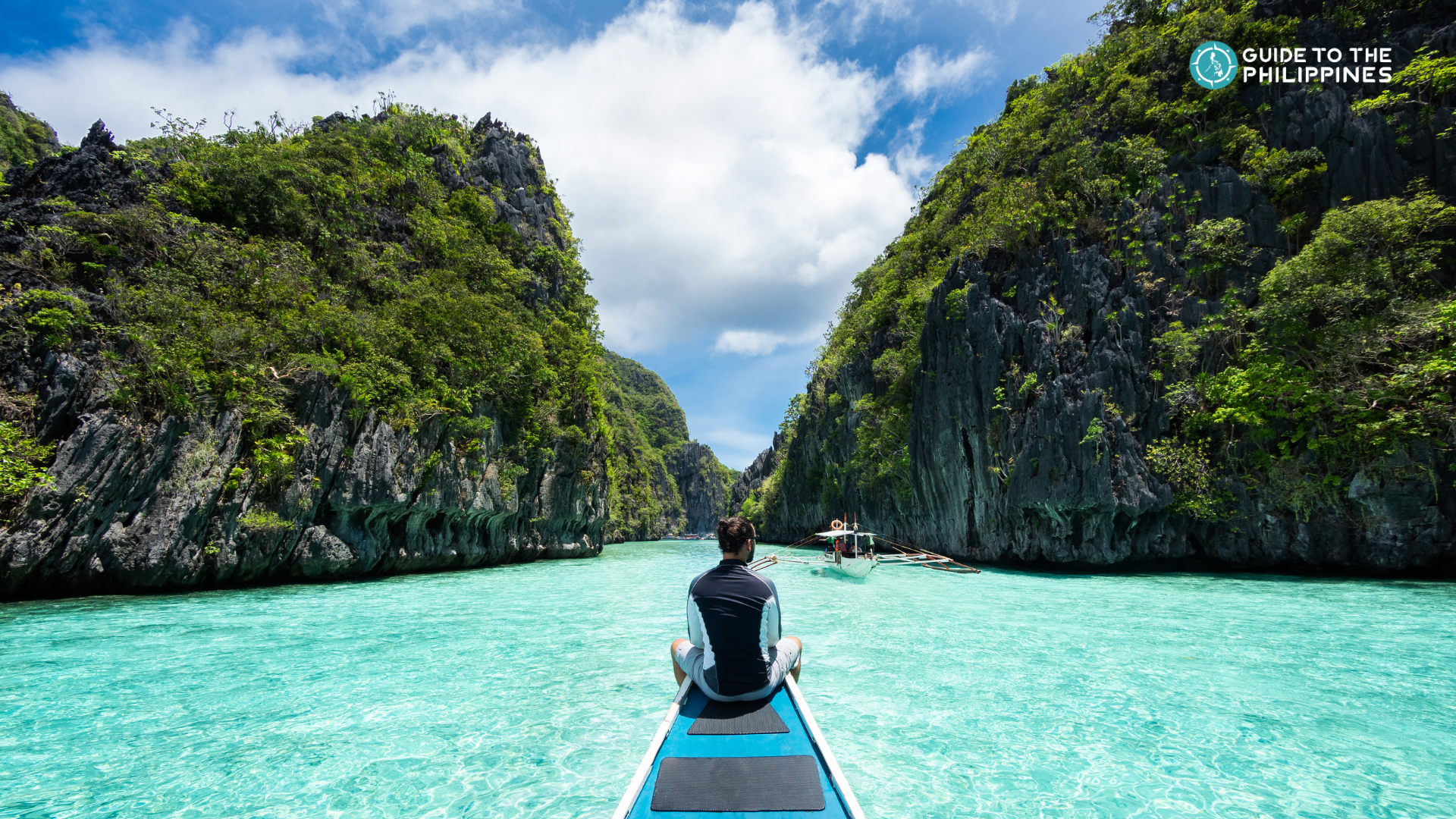 A traveler enjoying a boat ride through a stunning lagoon in El Nido town, Palawan Island.