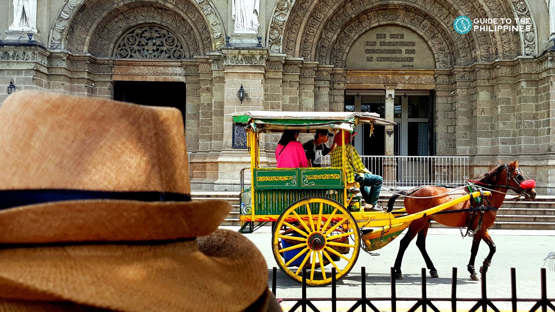 Tourists on a horse-drawn carriage (kalesa) in Intramuros, Manila