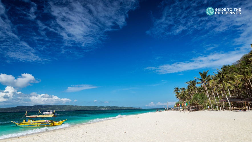 Boat on a Boracay island hopping tour docked by a beach Boat on a Boracay island hopping tour docked by a beach