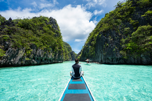 Discover the mesmerizing charm of Big Lagoon’s vibrant turquoise waters and dramatic cliffs during your tour package to Puerto Princesa City and El Nido Town on Palawan Island