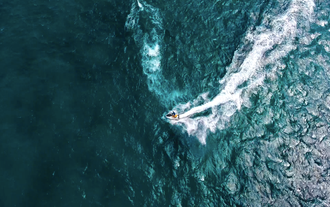 An aerial view of a jet ski adventure in Bohol Province, capturing the thrill of gliding across crystal-clear waters.