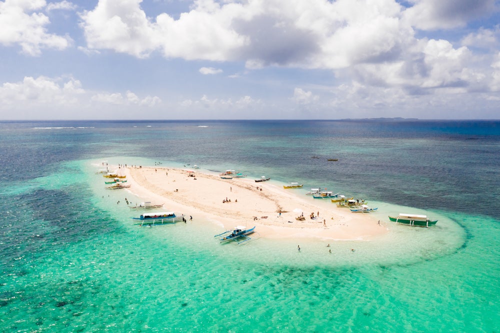 Enjoy the serene beauty of Naked Island, a breathtaking sandbar included in your Siargao Island tour package.