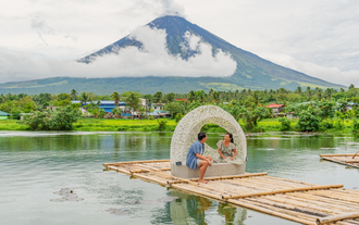 A couple enjoying the serene beauty of Sumlang Lake during a trip to Mayon Volcano in Albay Province