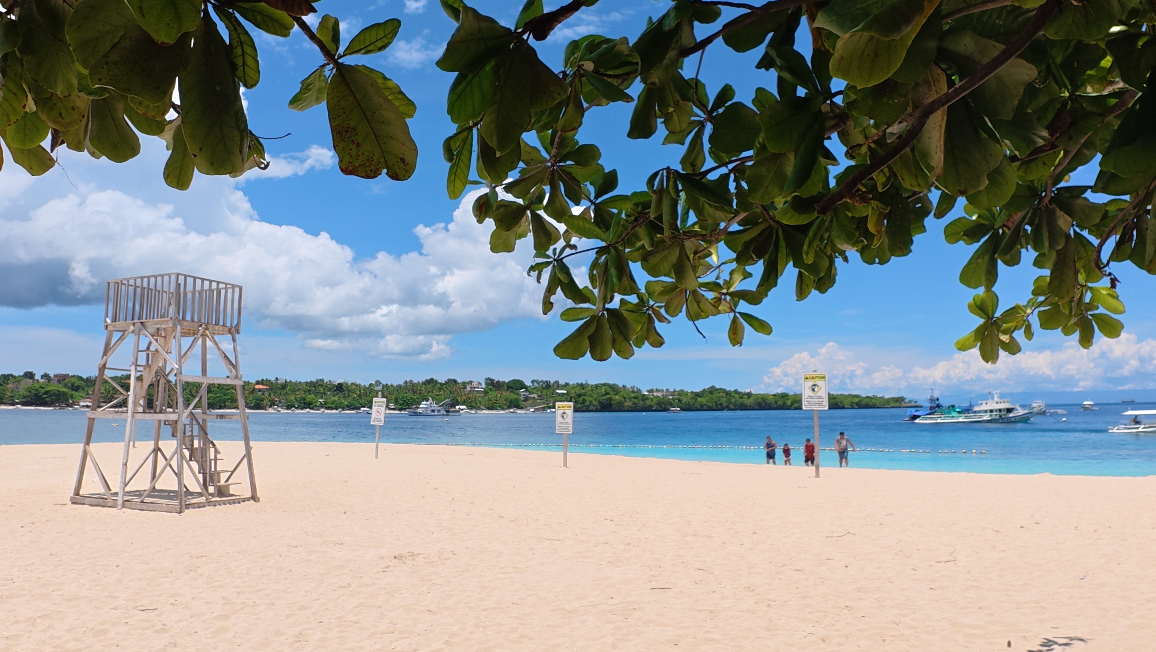 A peaceful beach on Tulang Diot Island, featuring powdery white sand and clear waters, is included in this Camotes Island tour