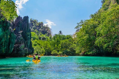 A boat with tourists going  inside Puerto Princesa Underground River