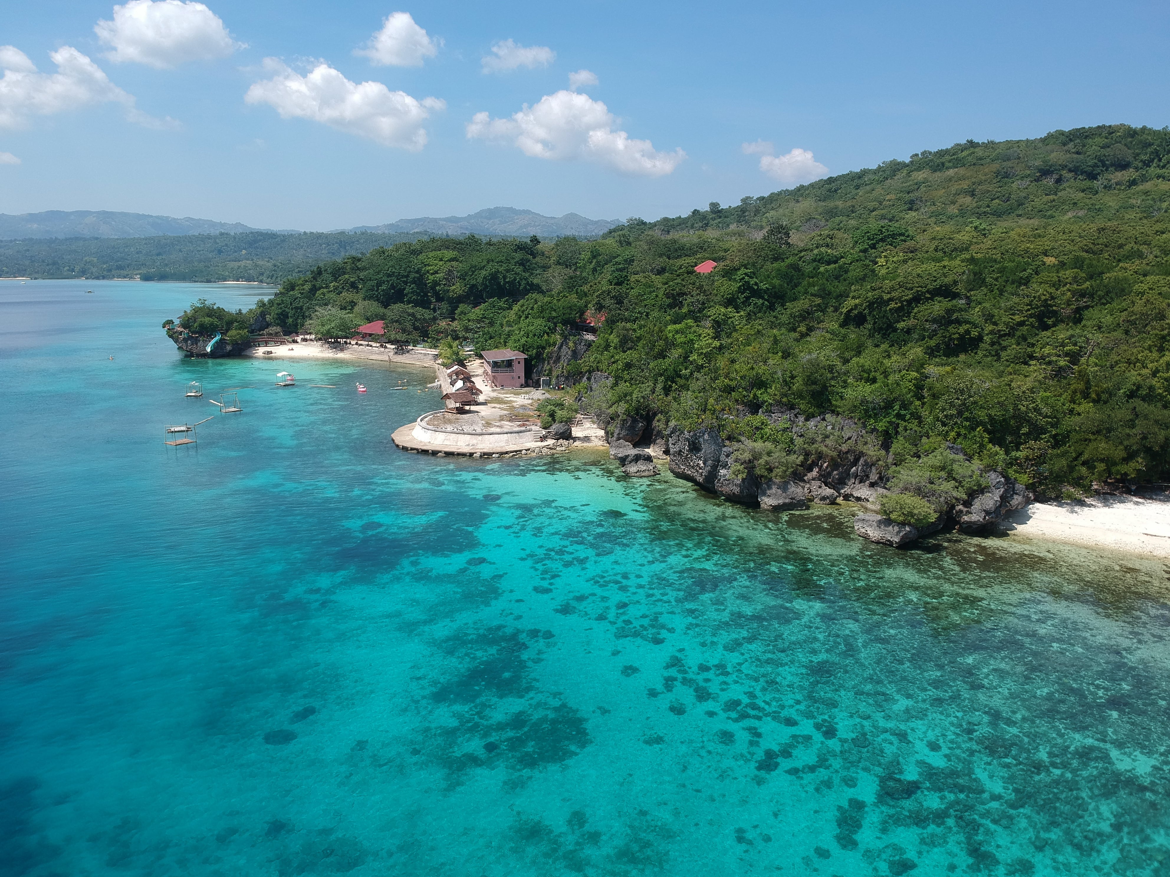 Experience the beauty of a pristine white sand beach with crystal-clear waters during your Siquijor Island tour package