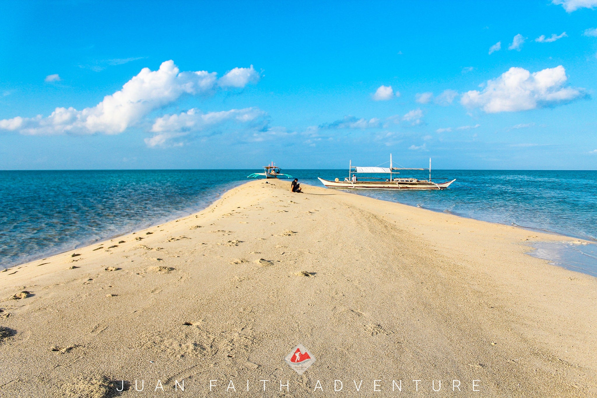 A tourist lounging on the pristine Biliran Sandbar during a Pagbilao island hopping tour in Quezon Province