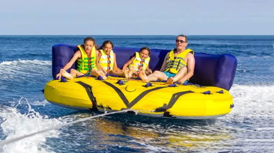 Friends enjoying a glider ride across the clear waters of Coron town, one of the water activities that is part of this experience