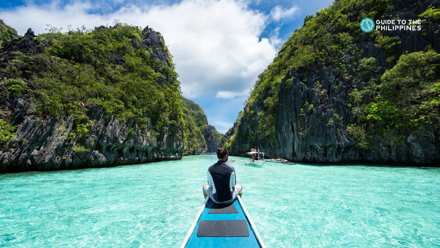 A traveler cruising down the stunning Big Lagoon in El Nido, Palawan. A traveler cruising down the stunning Big Lagoon in El Nido, Palawan.