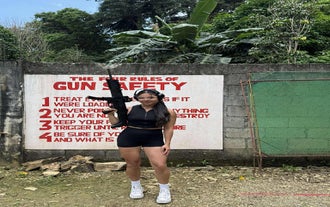 A  participant standing confidently with a firearm at the firing range near Boracay Island