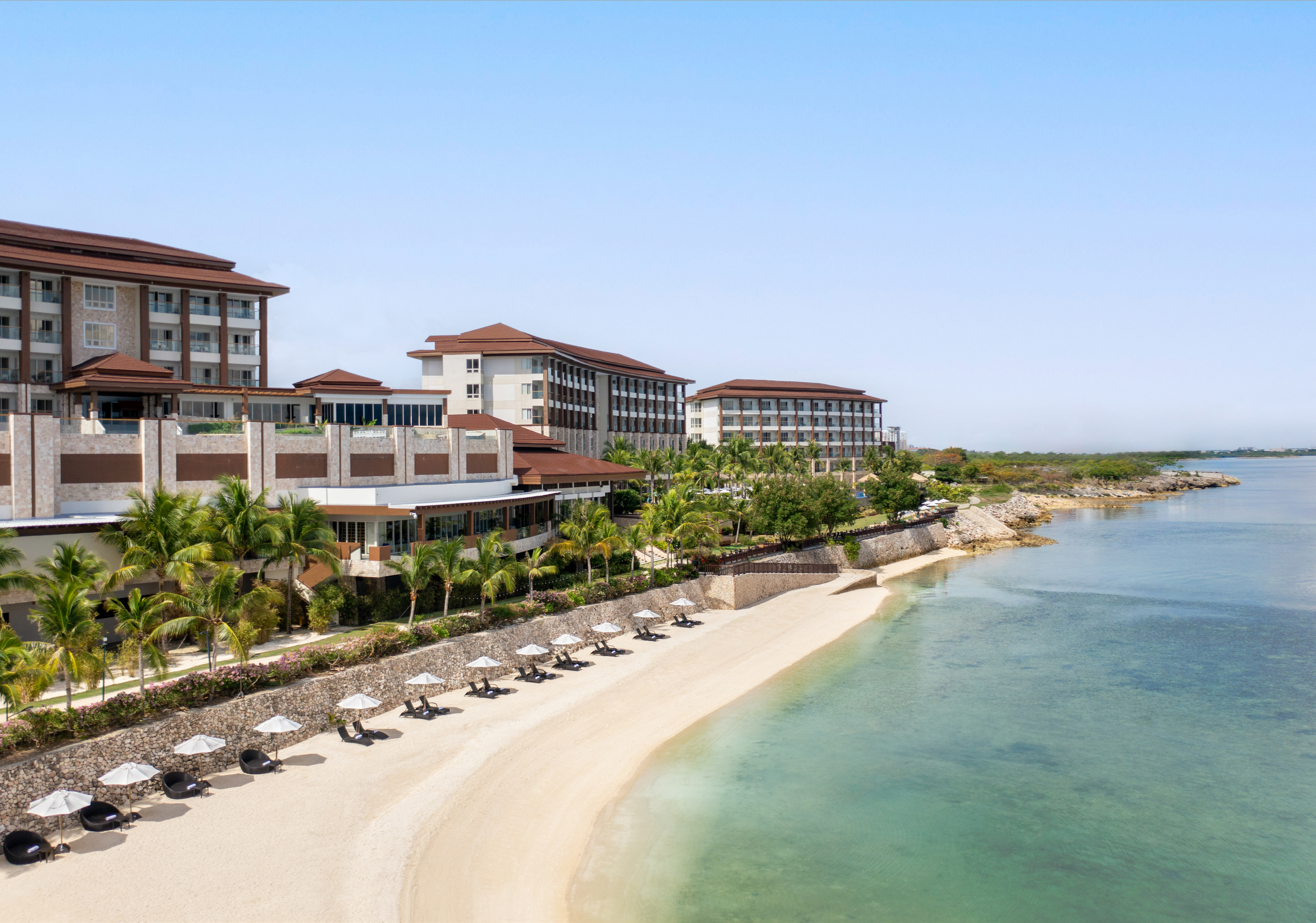 An aerial view of the pristine beach at Dusit Thani Mactan Resort in Cebu Province, which you can access with this day pass.