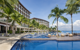 A bright daytime scene at one of the swimming pools inside Dusit Thani Mactan Resort, which you can access with this day pass.