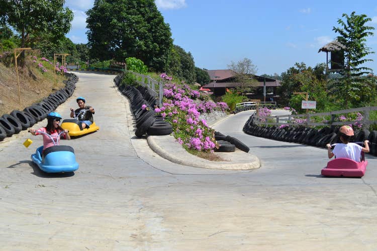 Kids smiling as they enjoy the Zooc ride, which you can avail as an add-on, with this day pass to Zoocobia Fun Zoo in Clark City