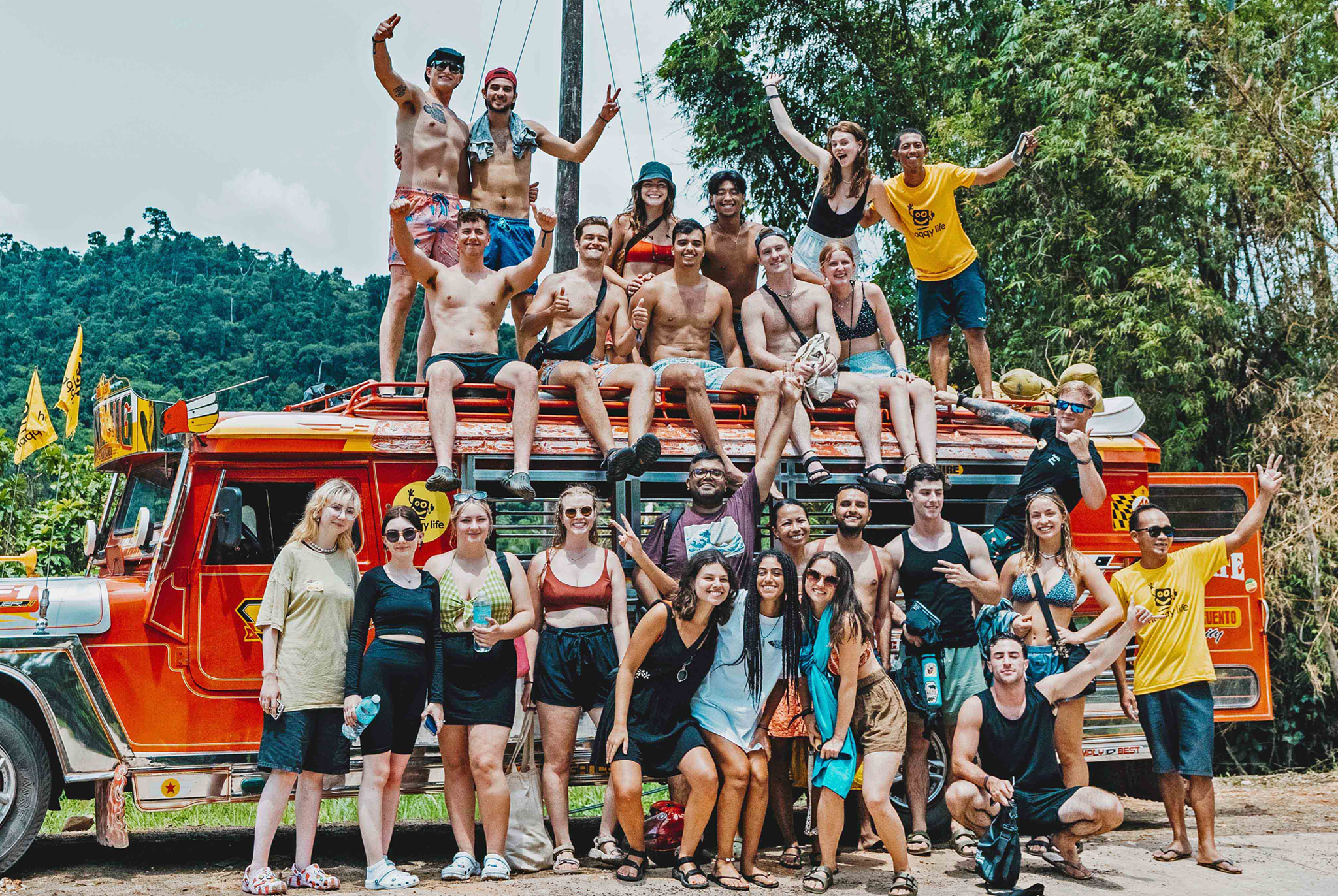 A group of travelers posing for photos beside a colorful jeepney on this fun tour in El Nido town
