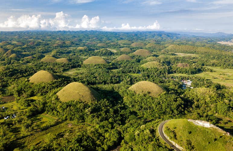 Marvel at the Chocolate Hills in Bohol Island, taking in the unique geological formations that resemble giant chocolate drops.