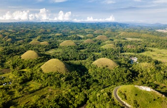 Marvel at the Chocolate Hills in Bohol Island, taking in the unique geological formations that resemble giant chocolate drops.
