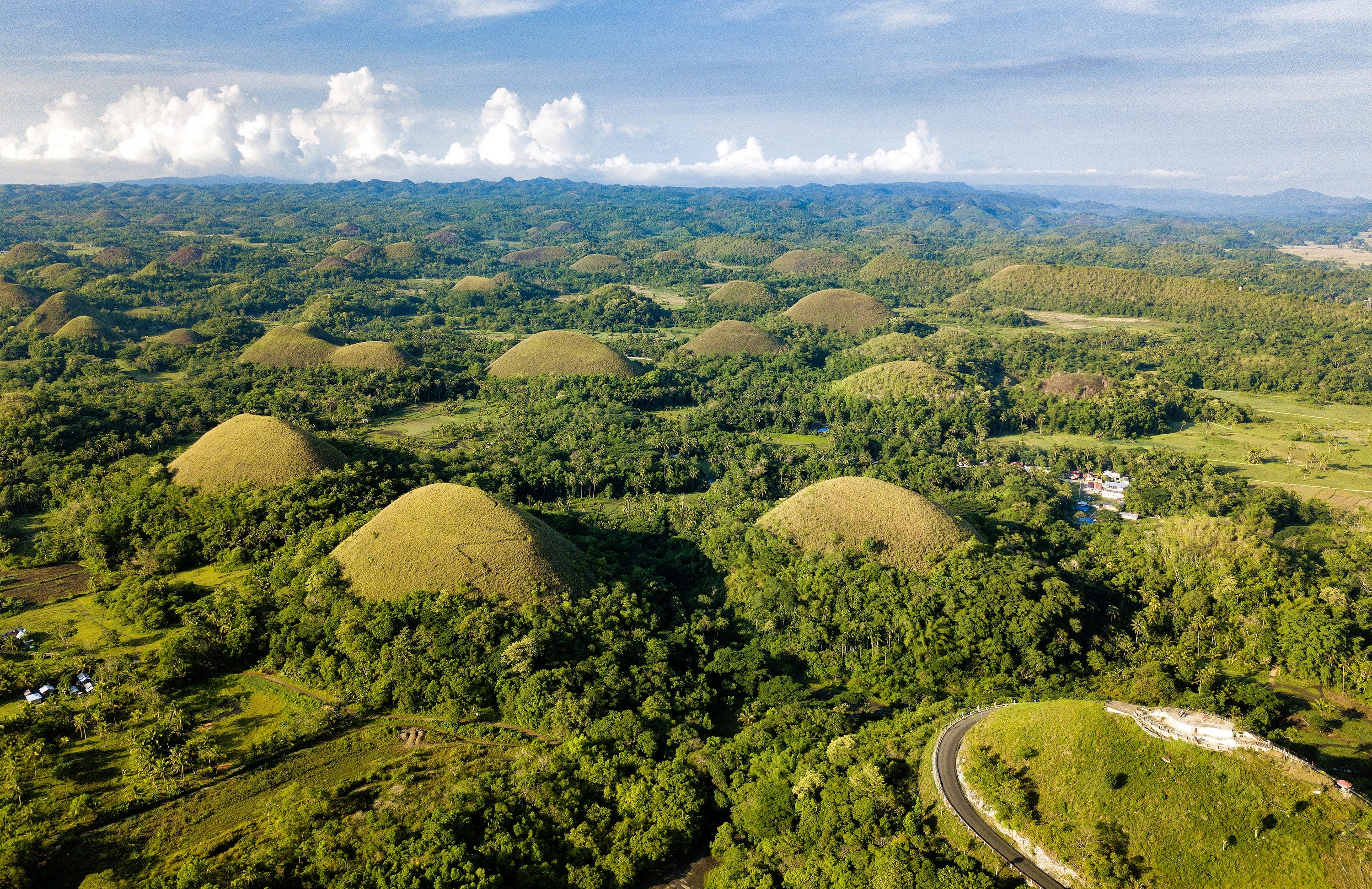 Marvel at the Chocolate Hills in Bohol Island, taking in the unique geological formations that resemble giant chocolate drops.