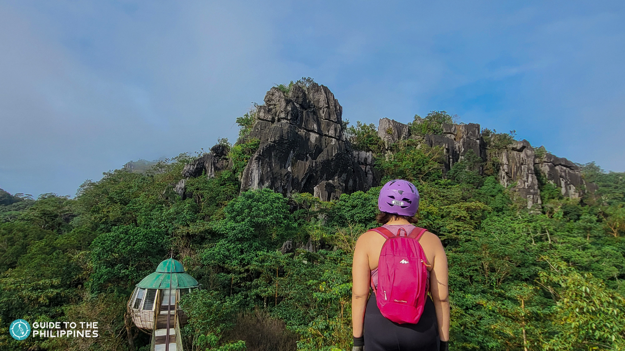 A traveler marvels at the lush forest and karst formations in Masungi Georeserve.