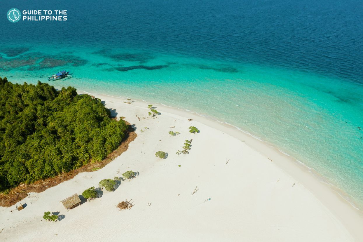 Aerial view of the pristine white sand beaches of Balabac town in Palawan Province.