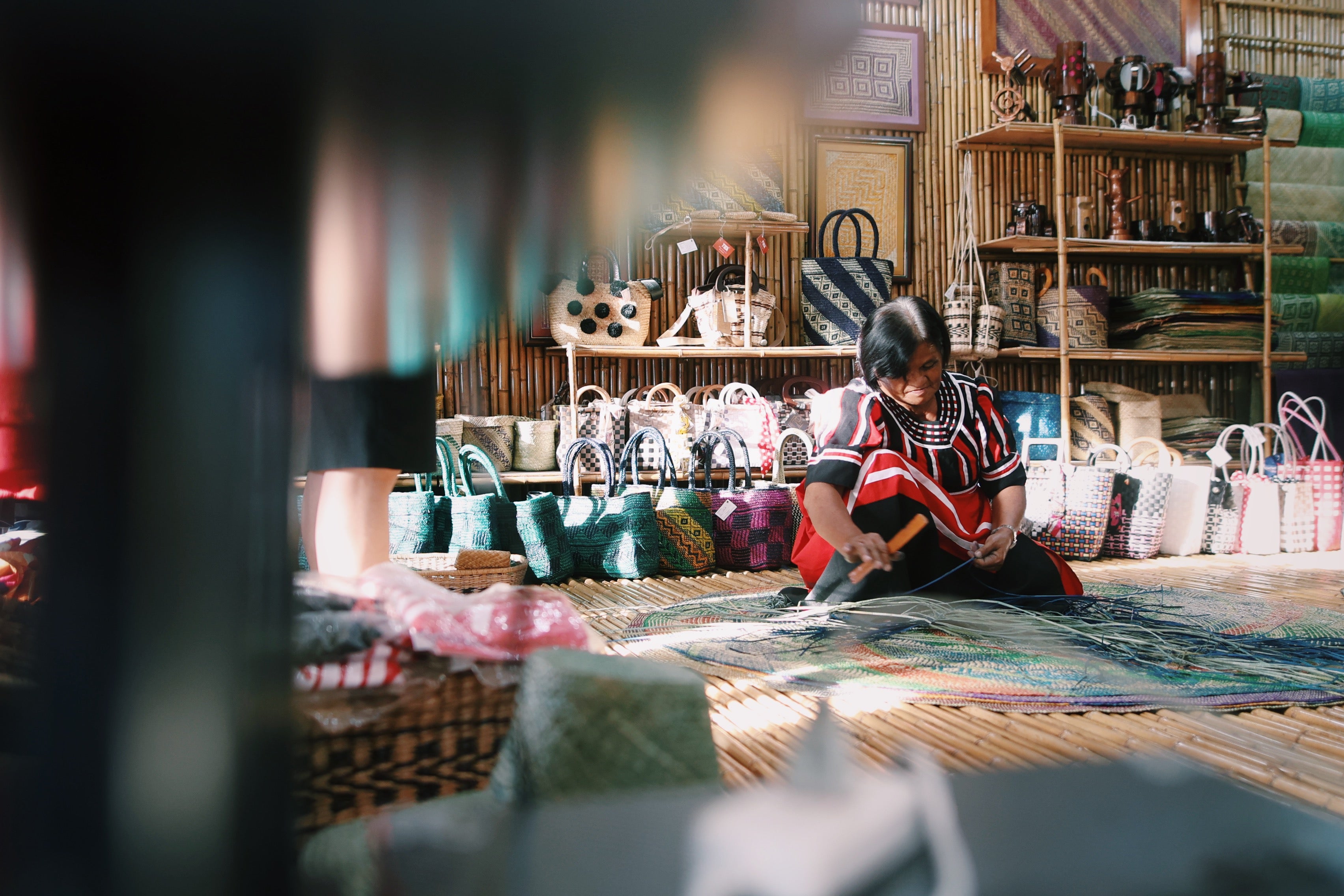 A local artisan demonstrating the traditional weaving practices of Bukidnon Province at the Tagolwanen Women Weavers' Association.